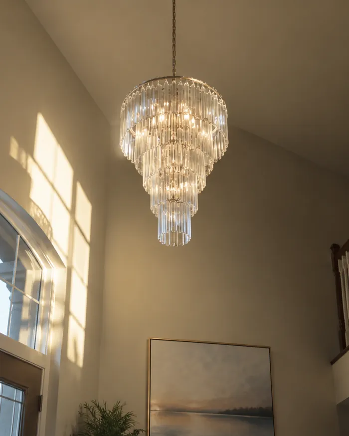 Glass chandelier hung on a tall slanted entry ceiling